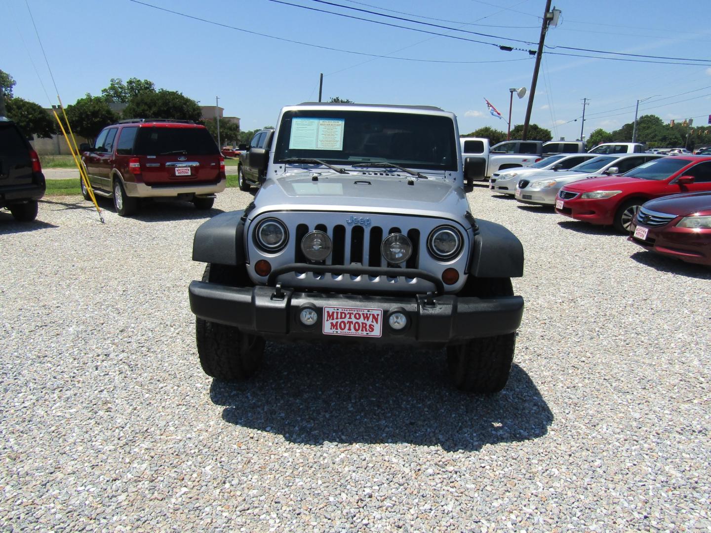 2013 Silver Jeep Wrangler Unlimited Sport 4WD (1C4BJWDG2DL) with an 3.6L V6 DOHC 24V FFV engine, Automatic transmission, located at 15016 S Hwy 231, Midland City, AL, 36350, (334) 983-3001, 31.306210, -85.495277 - Photo#1